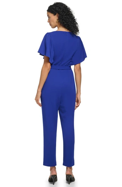 Shop Dkny Flutter Sleeve Jumpsuit In Berry Blue
