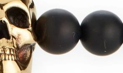 Shop Alexander Mcqueen Skull Beaded Bracelet In Black/ A.gold