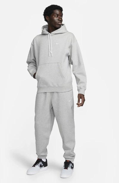 Shop Nike Solo Swoosh Fleece Sweatpants In Dark Grey Heather/ White