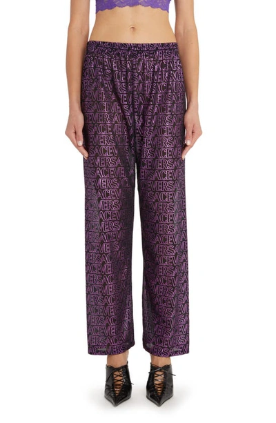 Shop Versace Logo Print Sheer Cover-up Pants In Black Tropical Pink Purple