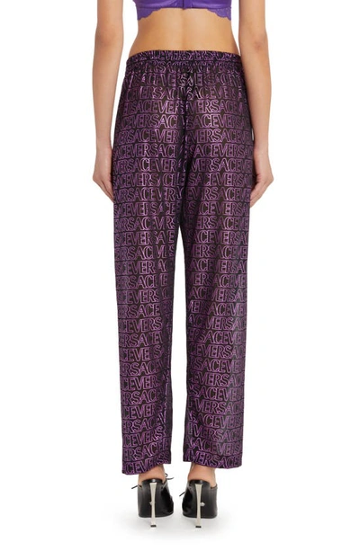 Shop Versace Logo Print Sheer Cover-up Pants In Black Tropical Pink Purple