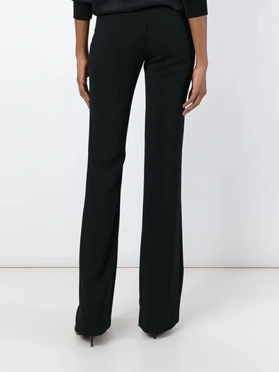 Shop Versace Bootcut Trousers In Black