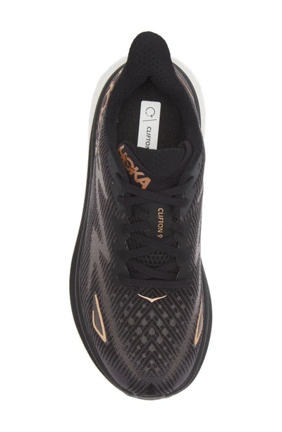 Shop Hoka Clifton 9 Running Shoe In Black / Copper