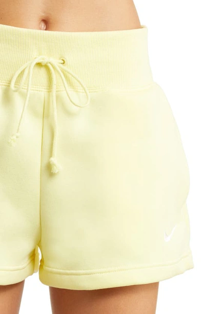Shop Nike Phoenix Fleece Knit Shorts In Lemon Chiffon/ Black