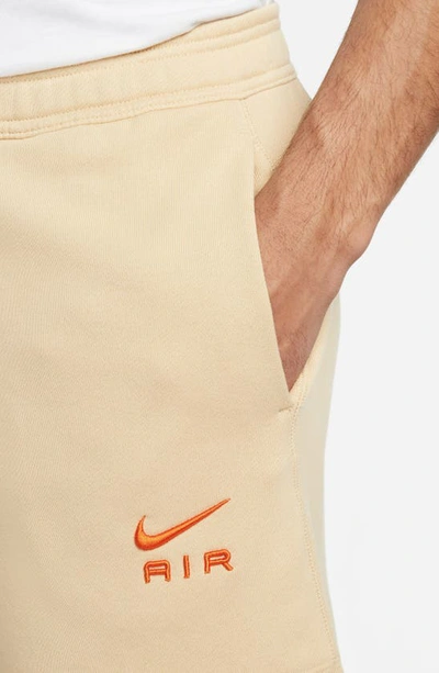 Shop Nike French Terry Shorts In Sesame/ Safety Orange