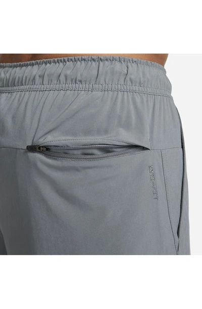 Shop Nike Dri-fit Unlimited 2-in-1 Versatile Shorts In Dark Smoke Grey/ Black