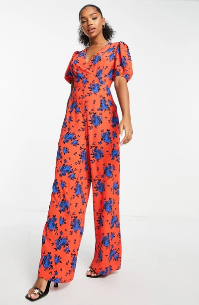 Shop Asos Design Floral Puff Sleeve Jumpsuit In Orange Multi