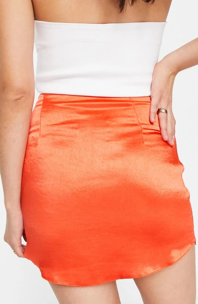 Shop Asos Design Curved Hem Satin Miniskirt In Red