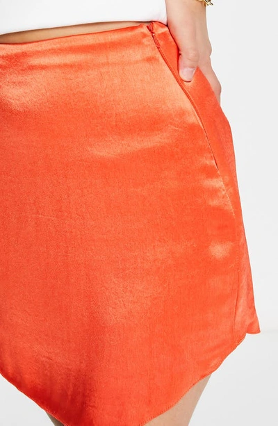 Shop Asos Design Curved Hem Satin Miniskirt In Red