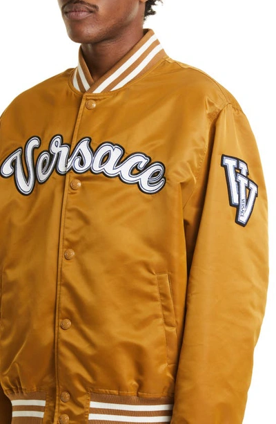 Shop Versace Varsity Script Satin Baseball Jacket In Toffee