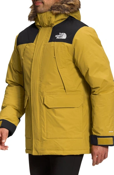 Shop The North Face Mcmurdo Waterproof 600 Fill Power Hooded Down Parka With Faux Fur Trim In Mineral Gold/ Black