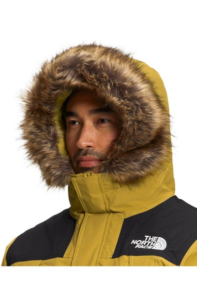 Shop The North Face Mcmurdo Waterproof 600 Fill Power Hooded Down Parka With Faux Fur Trim In Mineral Gold/ Black