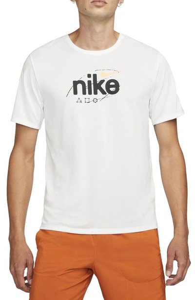 Shop Nike Miler Dri-fit Running Logo Graphic Tee In Summit White/ Peach Cream