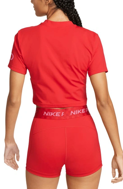 Shop Nike Pro Dri-fit Crop T-shirt In University Red/ Pinksicle