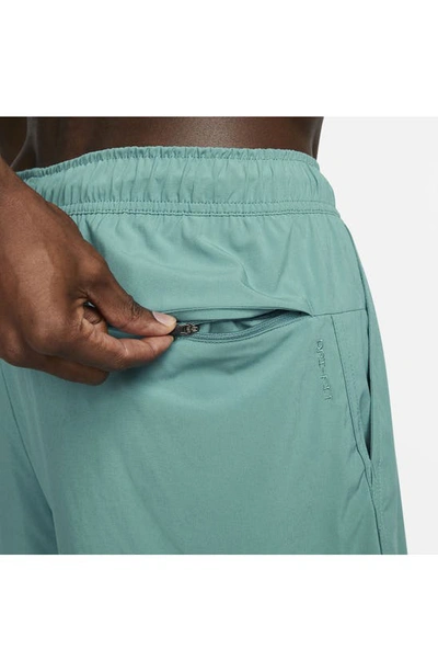 Shop Nike Dri-fit Unlimited 2-in-1 Versatile Shorts In Mineral Teal/ Spruce/ Black