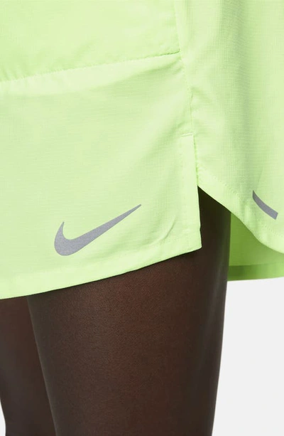 Shop Nike Dri-fit Stride 7-inch Brief-lined Running Shorts In Ghost Green/midnight Navy