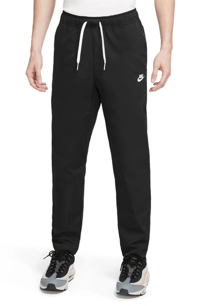 Shop Nike Woven Tapered Leg Pants In Black/ White