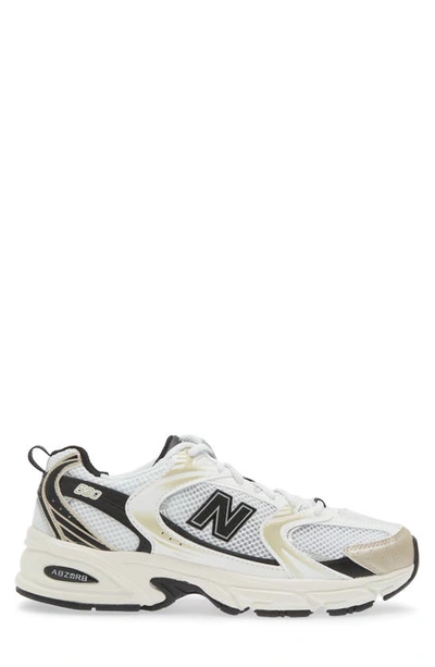 Shop New Balance Gender Inclusive 530 Sneaker In White/ Light Gold Metallic