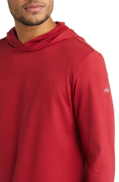 Shop Alo Yoga Conquer Reform Performance Hooded Long Sleeve T-shirt In Victory Red