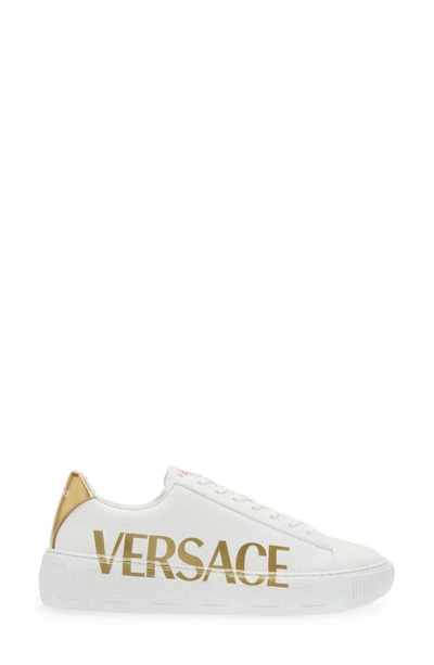 Shop Versace La Greca Logo Low Top Sneaker In White/ Gold