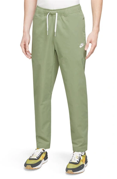 Shop Nike Woven Tapered Leg Pants In Oil Green/ White