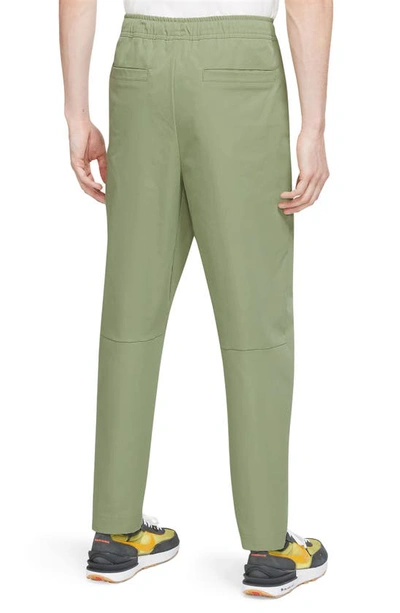 Shop Nike Woven Tapered Leg Pants In Oil Green/ White