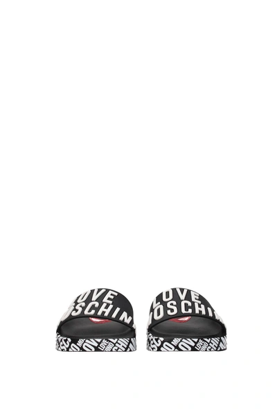 Shop Love Moschino Slippers And Clogs Pvc Black White