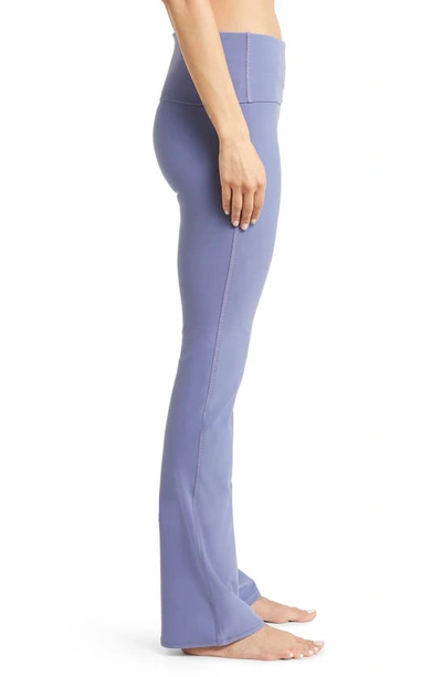 Shop Alo Yoga Foldover Waist Bootcut Alosoft Leggings In Infinity Blue