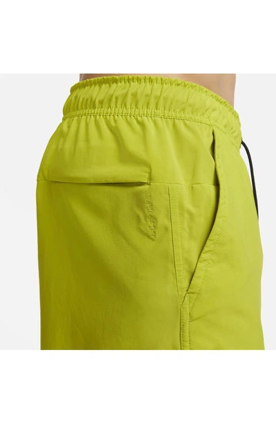 Shop Nike Dri-fit Unlimited 5-inch Athletic Shorts In Cactus/ Black