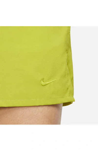 Shop Nike Dri-fit Unlimited 5-inch Athletic Shorts In Cactus/ Black