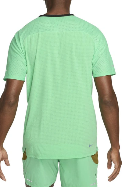 Shop Nike Dri-fit Trail Solar Chase Performance T-shirt In Spring Green/ Gridiron