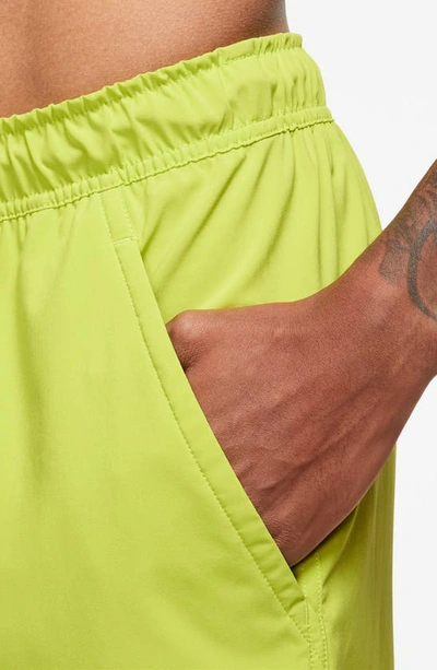 Shop Nike Dri-fit Unlimited 7-inch Unlined Athletic Shorts In Bright Cactus/ Black