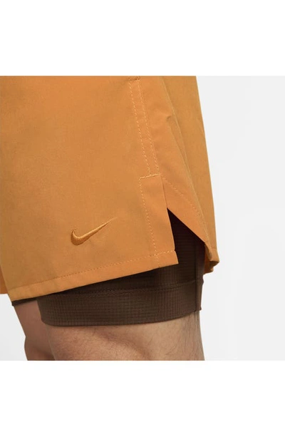 Shop Nike Dri-fit Unlimited 2-in-1 Versatile Shorts In Monarch/ Cacao/ Black