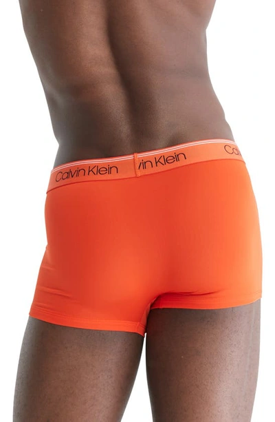 Shop Calvin Klein 3-pack Low Rise Microfiber Stretch Trunks In Orange/ Ivory/ Grey