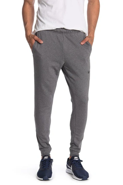 Shop Nike Tapered Jogger Pants In Dark Grey/ Black