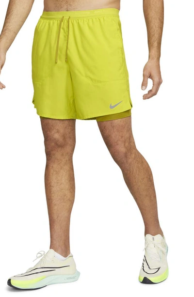 Shop Nike Dri-fit Stride 2-in-1 Running Shorts In Bright Cactus/moss/moss