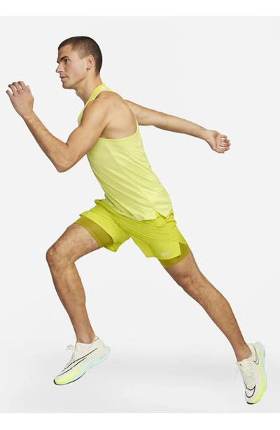 Shop Nike Dri-fit Stride 2-in-1 Running Shorts In Bright Cactus/moss/moss