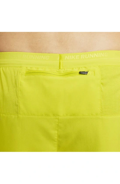 Shop Nike Dri-fit Stride 2-in-1 Running Shorts In Bright Cactus/moss/moss