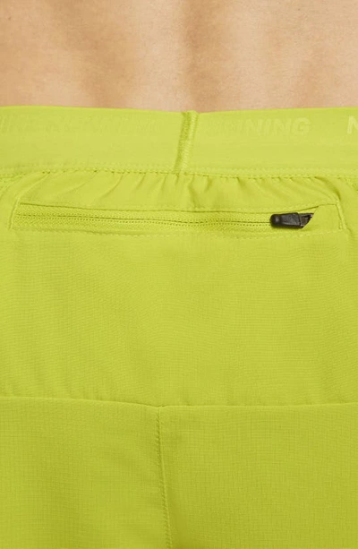 Shop Nike Dri-fit Stride 5-inch Running Shorts In Bright Cactus/moss