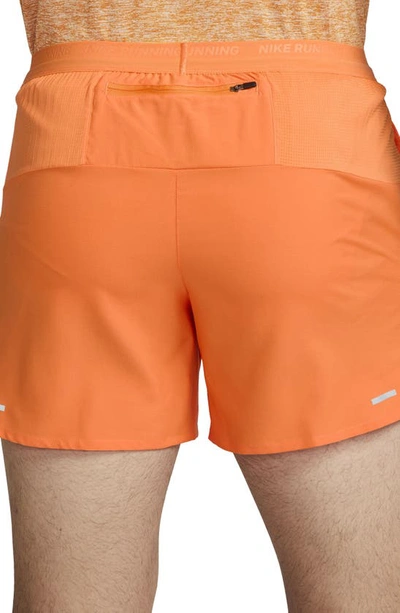 Shop Nike Dri-fit Stride 5-inch Running Shorts In Bright Mandarin/dark Russet