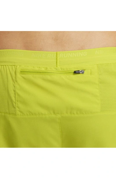 Shop Nike Dri-fit Stride Hybrid Running Shorts In Bright Cactus/moss/moss