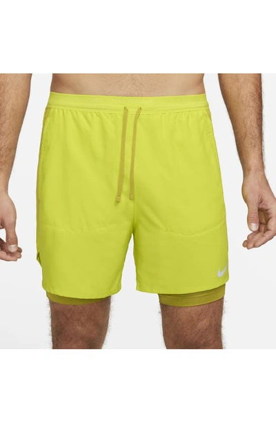 Shop Nike Dri-fit Stride Hybrid Running Shorts In Bright Cactus/moss/moss