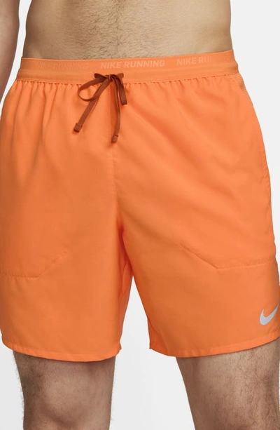 Shop Nike Dri-fit Stride 7-inch Brief-lined Running Shorts In Bright Mandarin/dark Russet