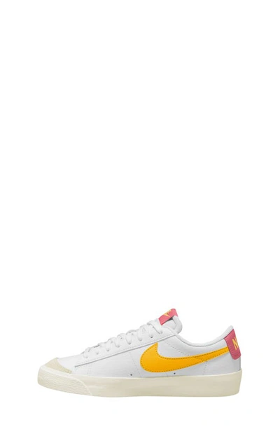 Shop Nike Kids' Blazer Low '77 Low Top Sneaker In White/ Gold/ Sail/ Orange