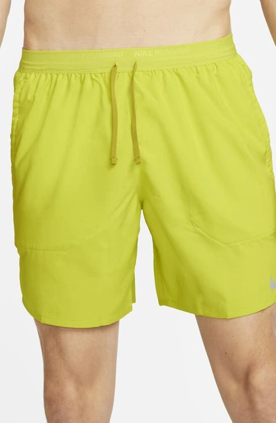 Shop Nike Dri-fit Stride 7-inch Brief-lined Running Shorts In Bright Cactus/moss