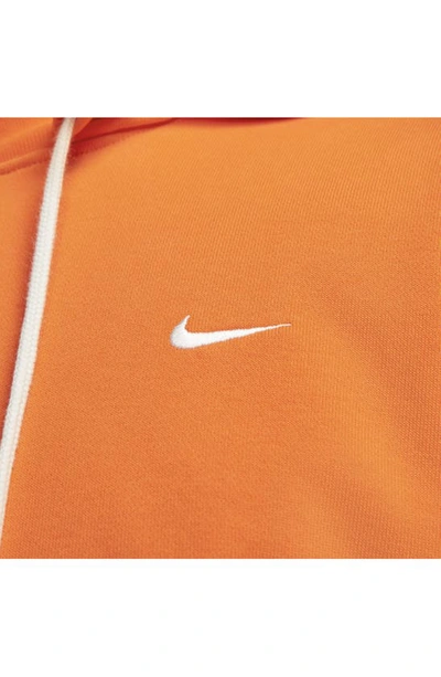 Shop Nike Dri-fit Standard Issue Hoodie Sweatshirt In Safety Orange/ Pale Ivory