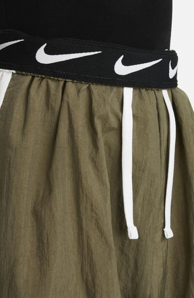 Shop Nike Kids' Sportswear Side Stripe Track Pants In Medium Olive/ White/ White