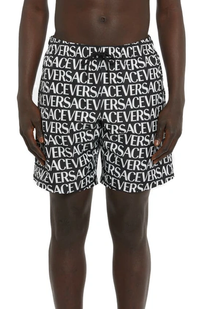 Shop Versace Logo Print Swim Trunks In Black/ White