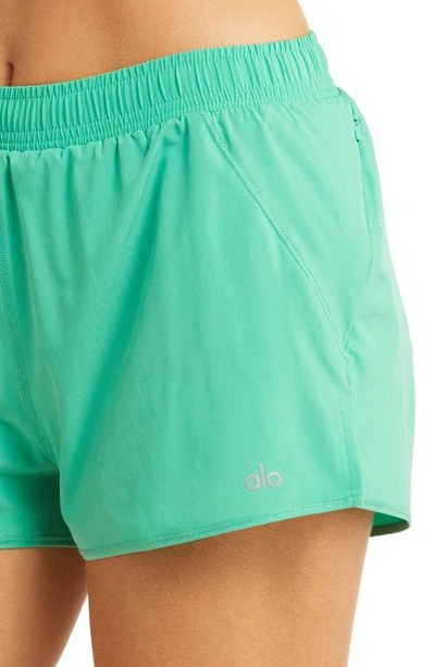 Shop Alo Yoga Stride Shorts In Lettuce