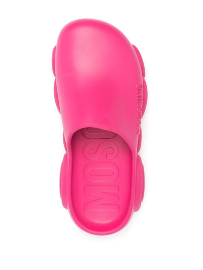 Shop Moschino Mules With Embossed Logo In Pink &amp; Purple